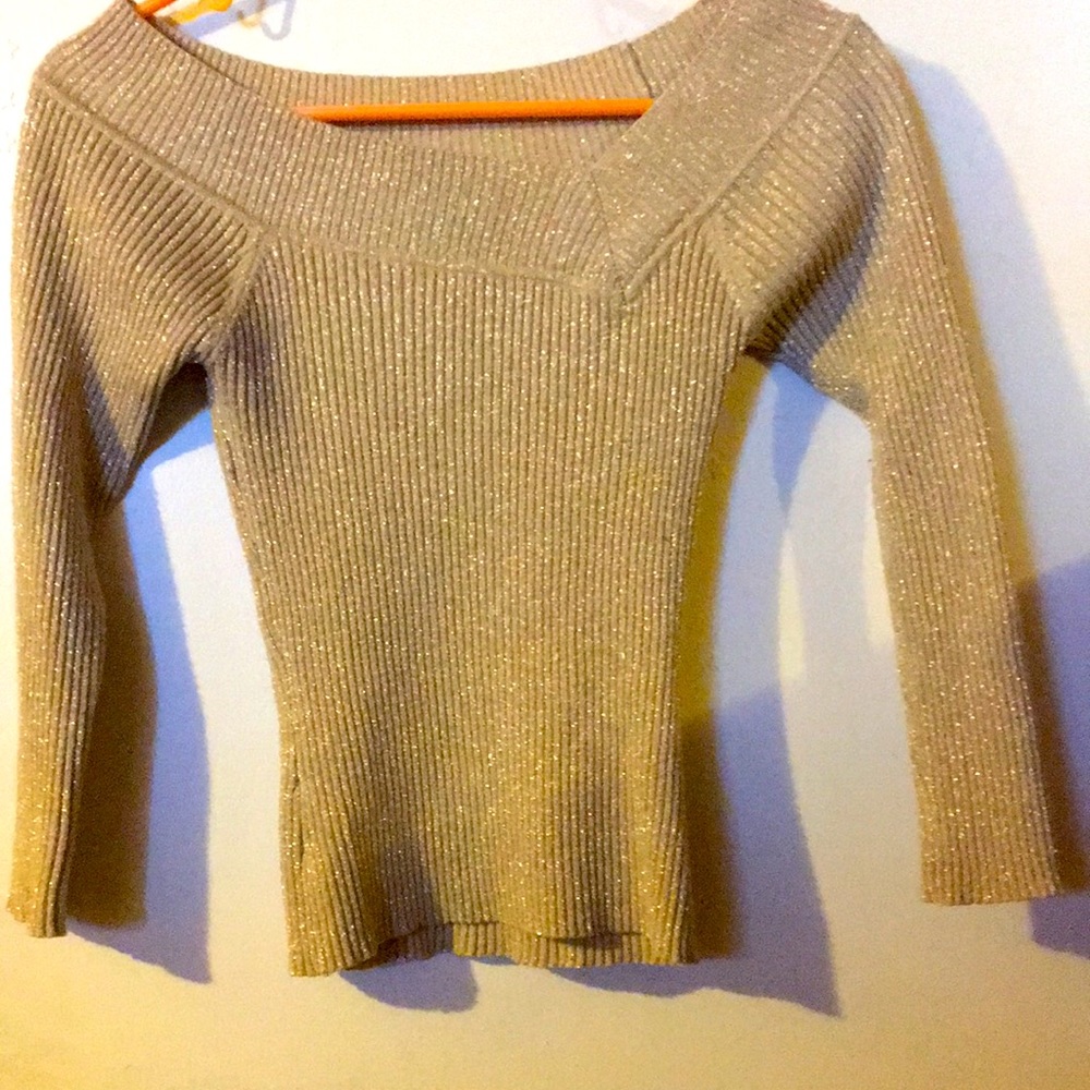 It’s a gold colored sweater with sparkles, 3/4 sleeves.